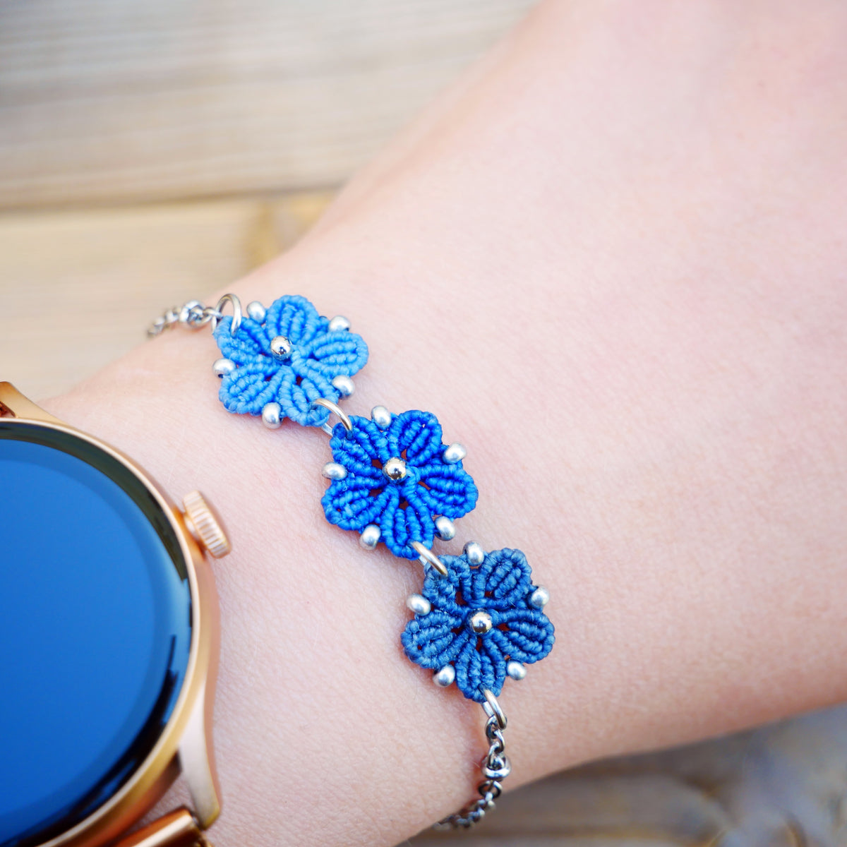 Bracelet Blossom orné de trois fleurs en micro-macramé en camaïeu de Bleu sur chaîne perlée argentée, bijou fleuri fait main par Macram’Elo Créations.